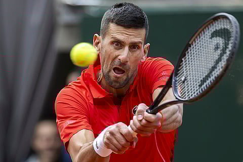 Novak Djokovic returns a ball to Tallon Griekspoor